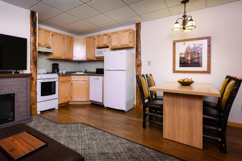 a kitchen with a table and a white refrigerator at Stoneridge Resort in Blanchard
