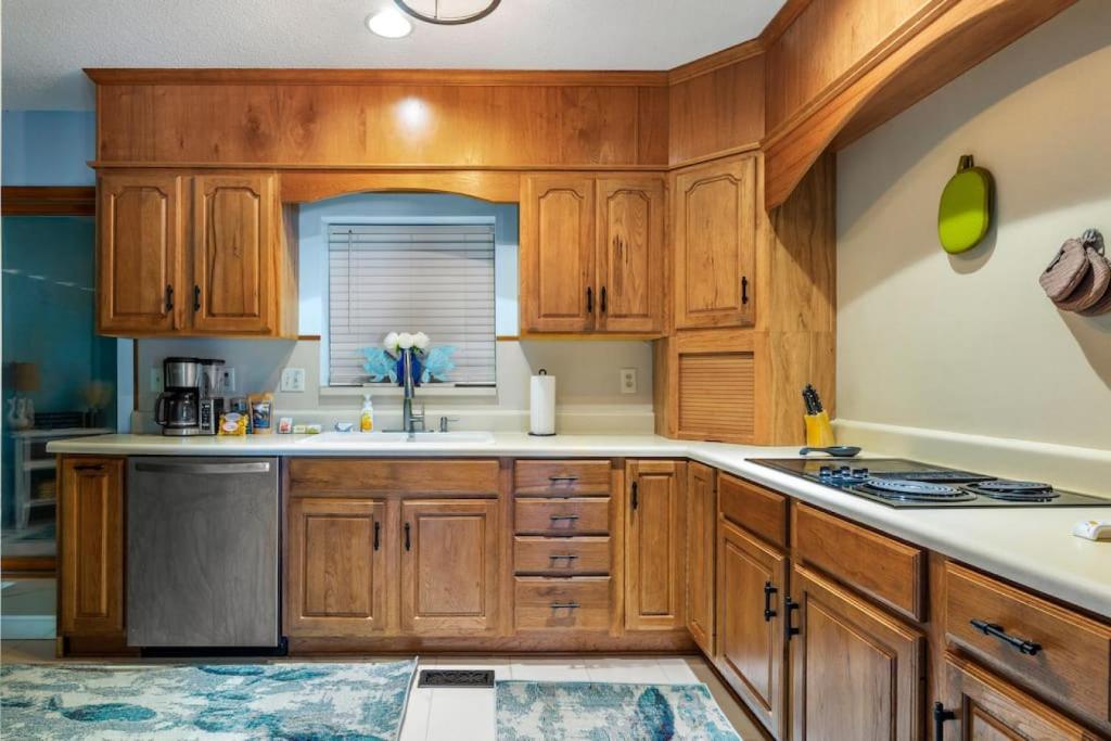 a kitchen with wooden cabinets and a sink at Vintage Sunrise Home-Lake View in Lake Murray Shores