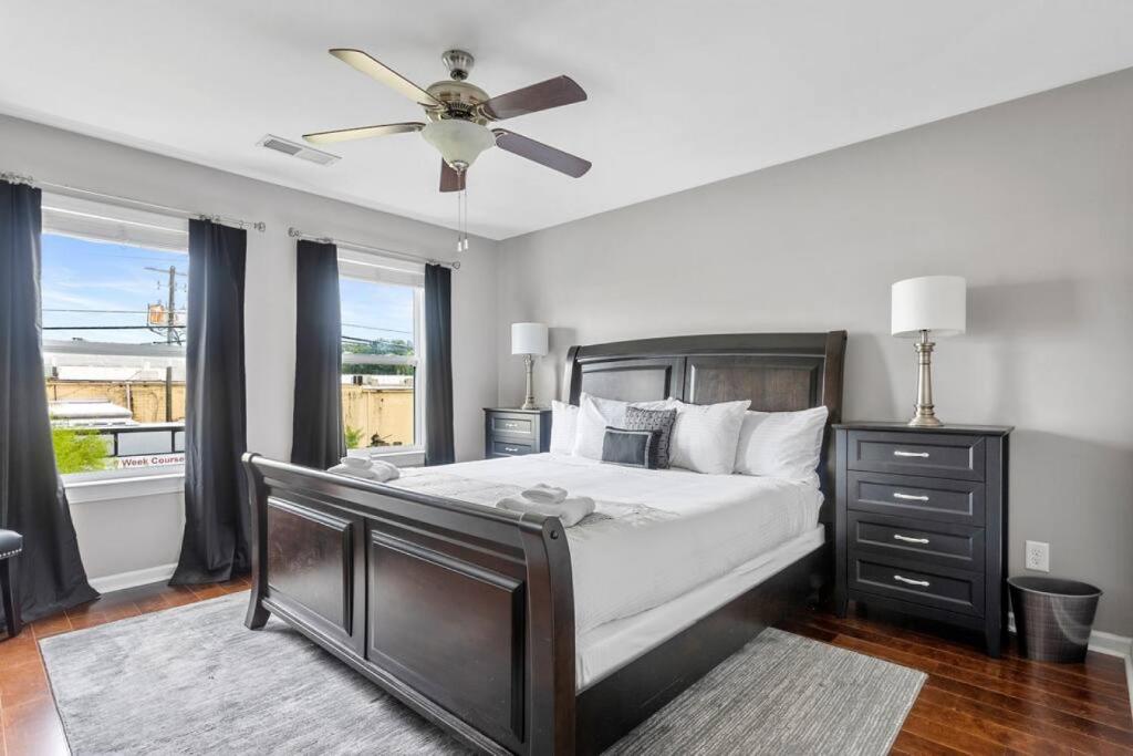 a bedroom with a large bed with a ceiling fan at Contemporary 3BR in Columbia
