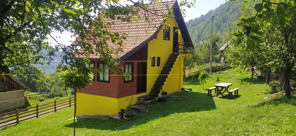 una pequeña casa en medio de un campo en Vikendica Studenac, en Bajina Bašta