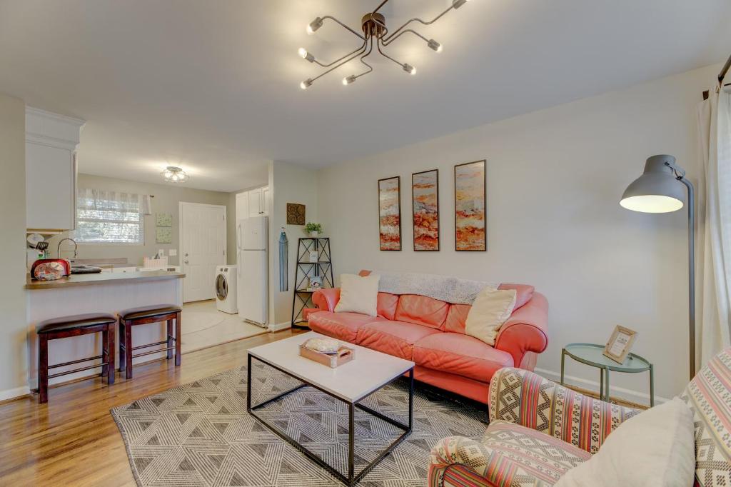 a living room with a red couch and a kitchen at Comfy and Convenient Condo in Columbia