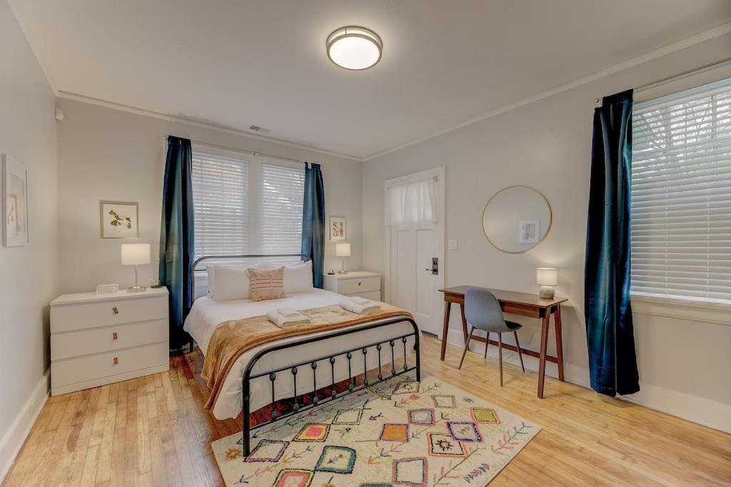 a bedroom with a bed and a table and a desk at The Douglas Apartment in Columbia