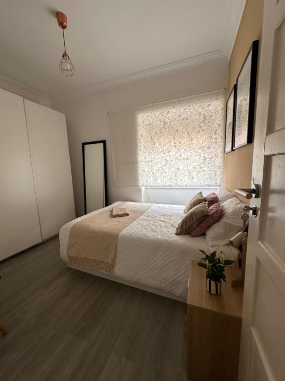 a bedroom with a large bed and a window at Guest ROOM in Lisbon