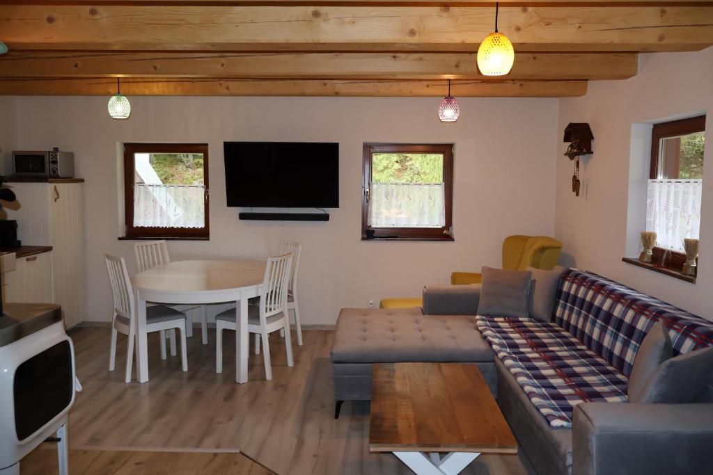 ein Wohnzimmer mit einem Sofa und einem Tisch in der Unterkunft Jariabka Chalet Zrub Nízke Tatry in Jarabá