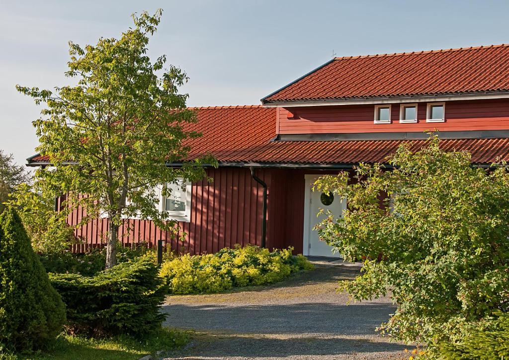 una casa roja con techo rojo y entrada en Långänge Bed & Breakfast, en Tandsbyn