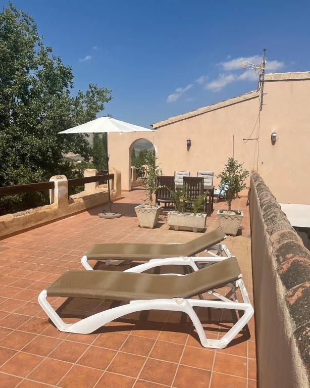 a couple of lounge chairs sitting on a patio at Casas Demi Dos in Vélez Blanco