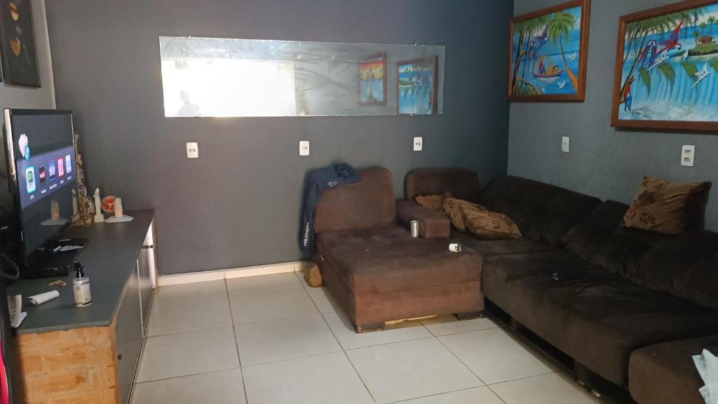 a living room with a couch and a tv at Casa para aluguel em rio verde in Rio Verde