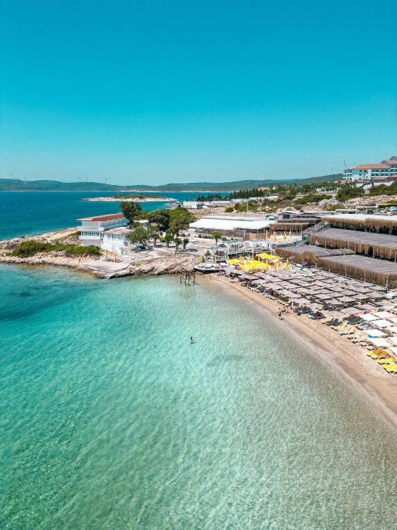 an aerial view of a beach with boats and buildings at Lotus City Sığacık in Seferihisar