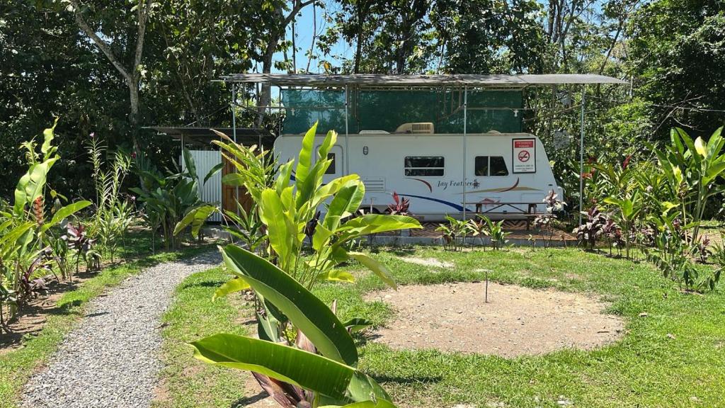 a rv is parked in a garden with a path at Ciudad Rodante La Fortuna , ave 309 in Fortuna