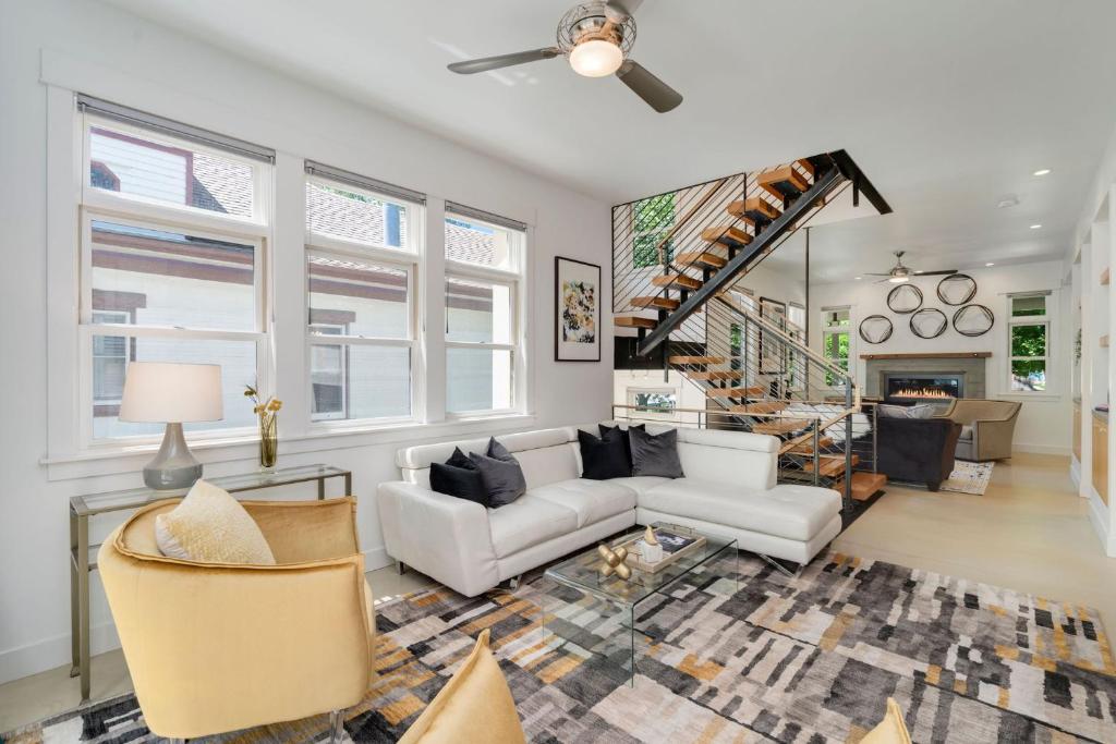 a living room with a couch and a fireplace at Old Town Oasis - Spacious Artisan Home in Old Town in Fort Collins
