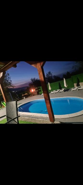 a view of a swimming pool at night at Villa maskara in Bihać