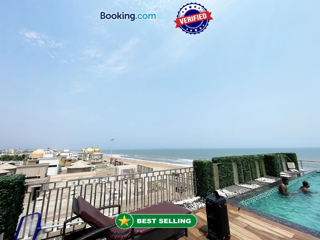 a view of the beach from the balcony of a beach house at Hotel TBS sea view ! Puri Swimming-pool, fully-air-conditioned-hotel with-lift-and-parking-facility breakfast-included in Puri