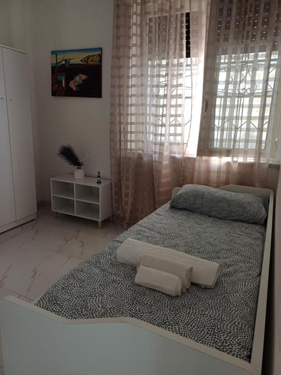 a bedroom with a bed with two pillows on it at Casa Gimaga in Pozzuoli