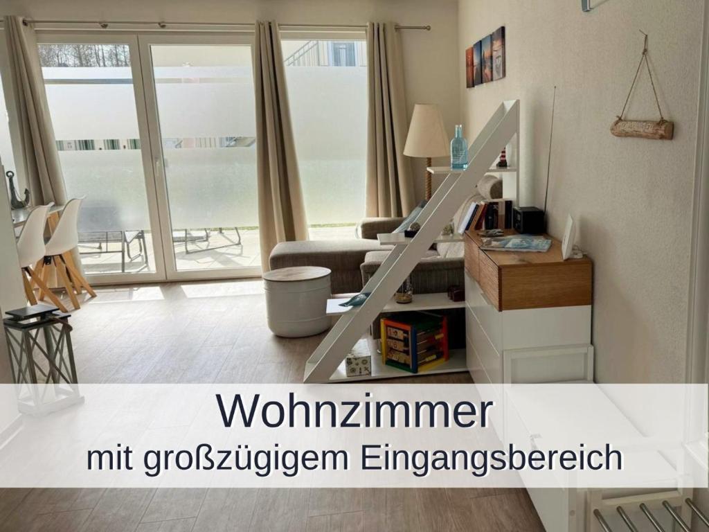 a living room with a staircase in a living room at Ferienwohnung Heimathafen Küstenwald in Gelbensande