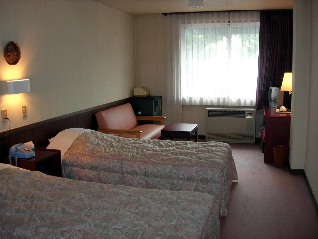 Postel nebo postele na pokoji v ubytování Hotel Weisser Hof Happei