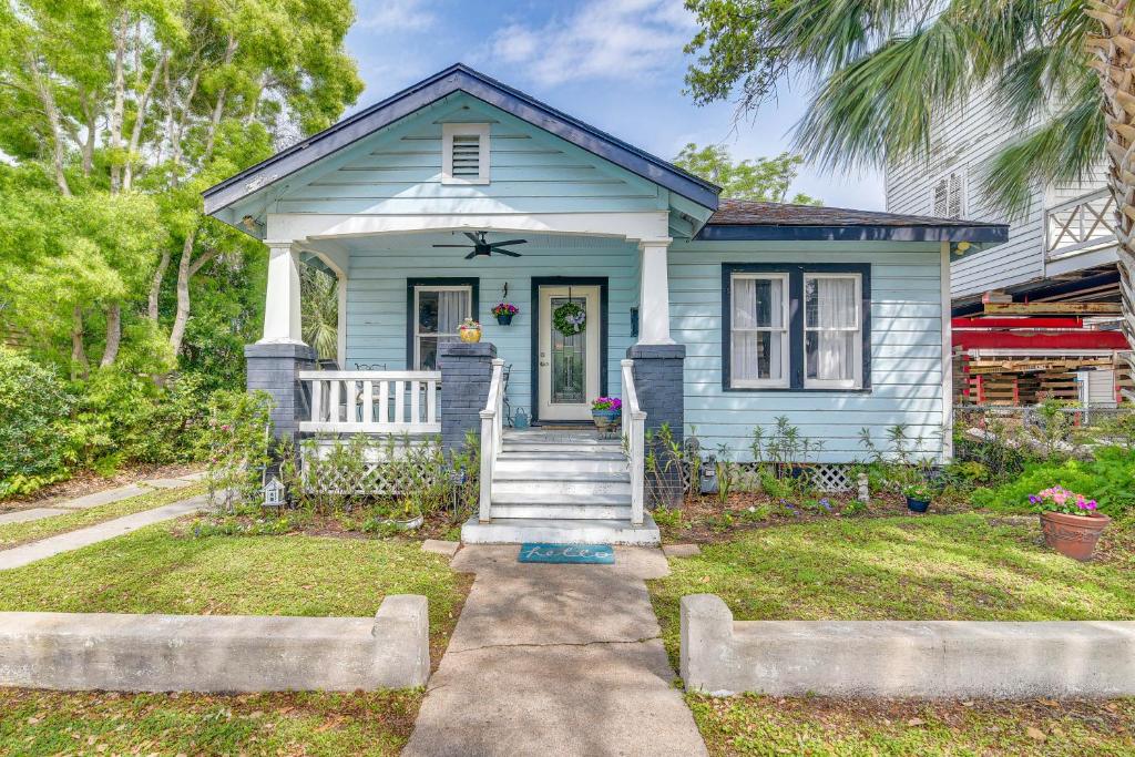 a blue house with a front porch and stairs at Pet-Friendly Galveston Bungalow, half Mi to Beach! in Galveston