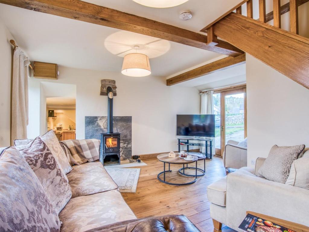 a living room with a couch and a fireplace at 3 Bed in Hartington 77739 in Hartington