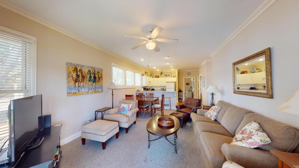 a living room with a couch and a table at Golf and Beach: 2BR Lakeside Villa with Lake Views in Pawleys Island