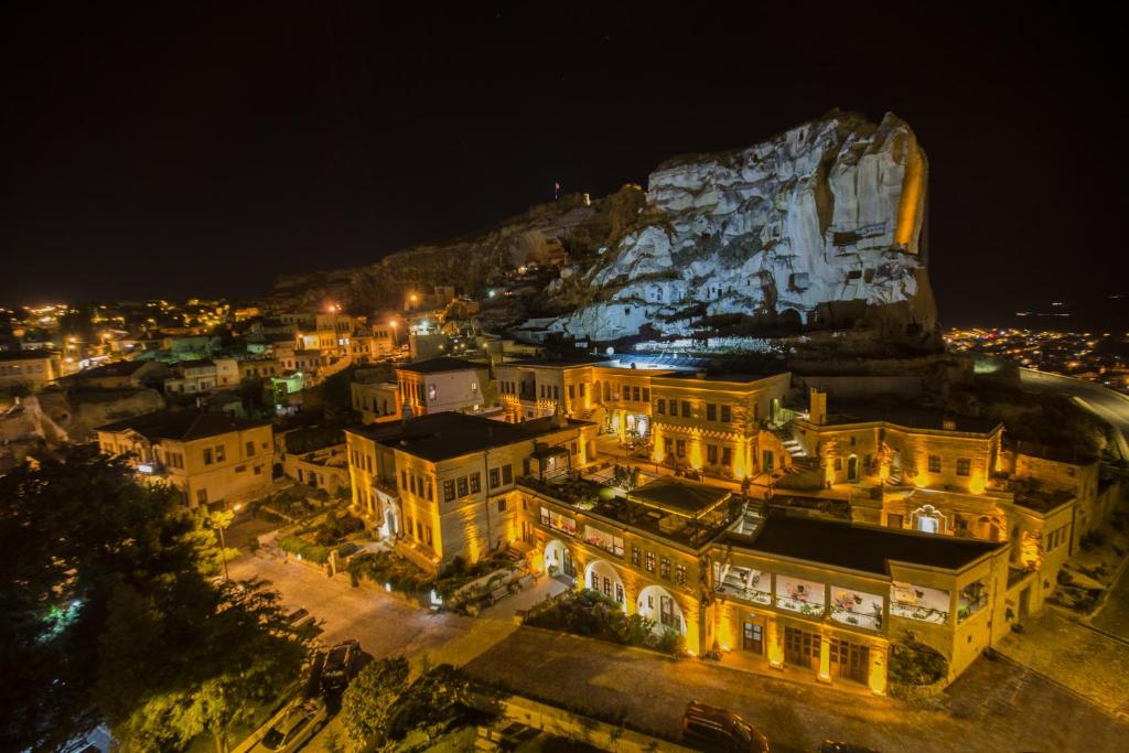 a view of a city at night with a rock at Fresco Cave Suites Cappadocia in Urgup