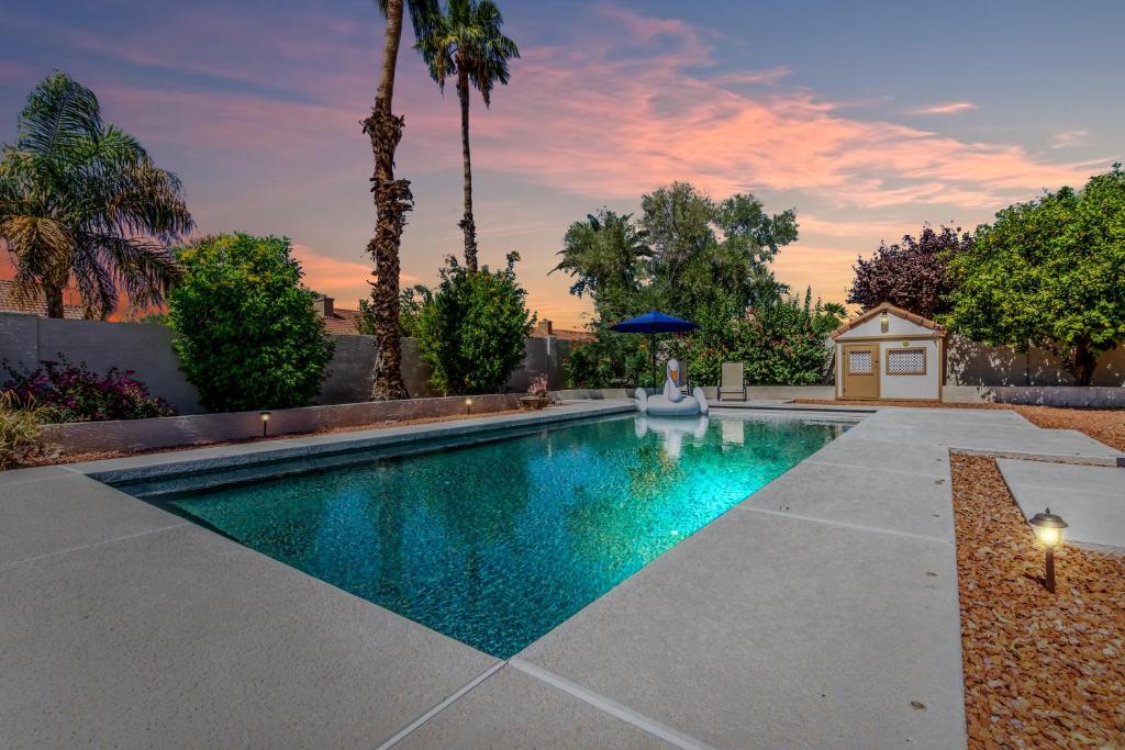 a swimming pool in a backyard with palm trees at Cobalt Serenity-Private Pool-North Scottsdale in Phoenix