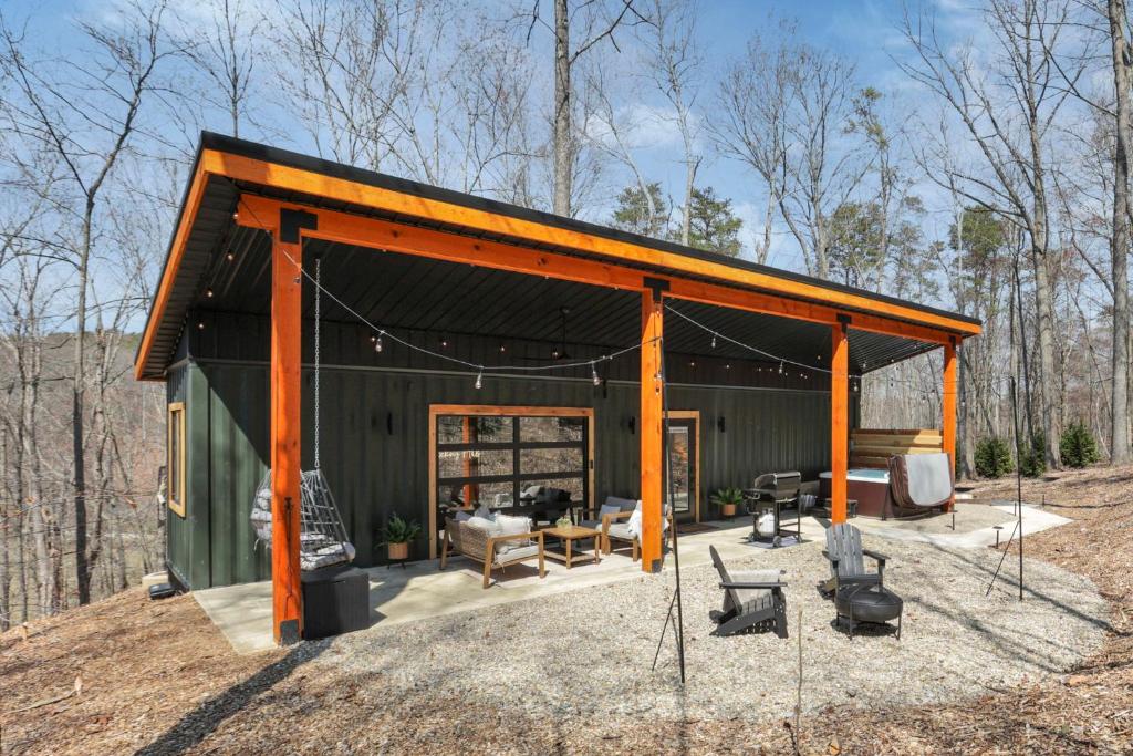 a green house with an orange roof at The Hillside Retreat - Tiny Home in Hocking Hills in Logan