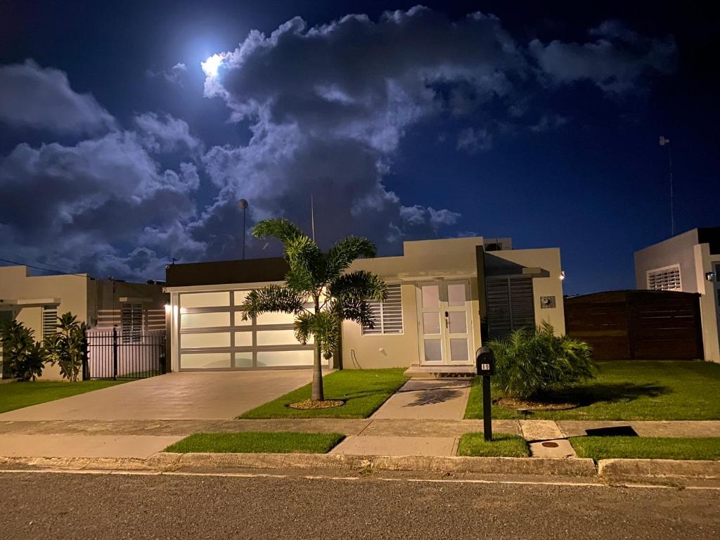 a house with a garage at night with the moon at Casa Orillia's Del Mar in Isabela