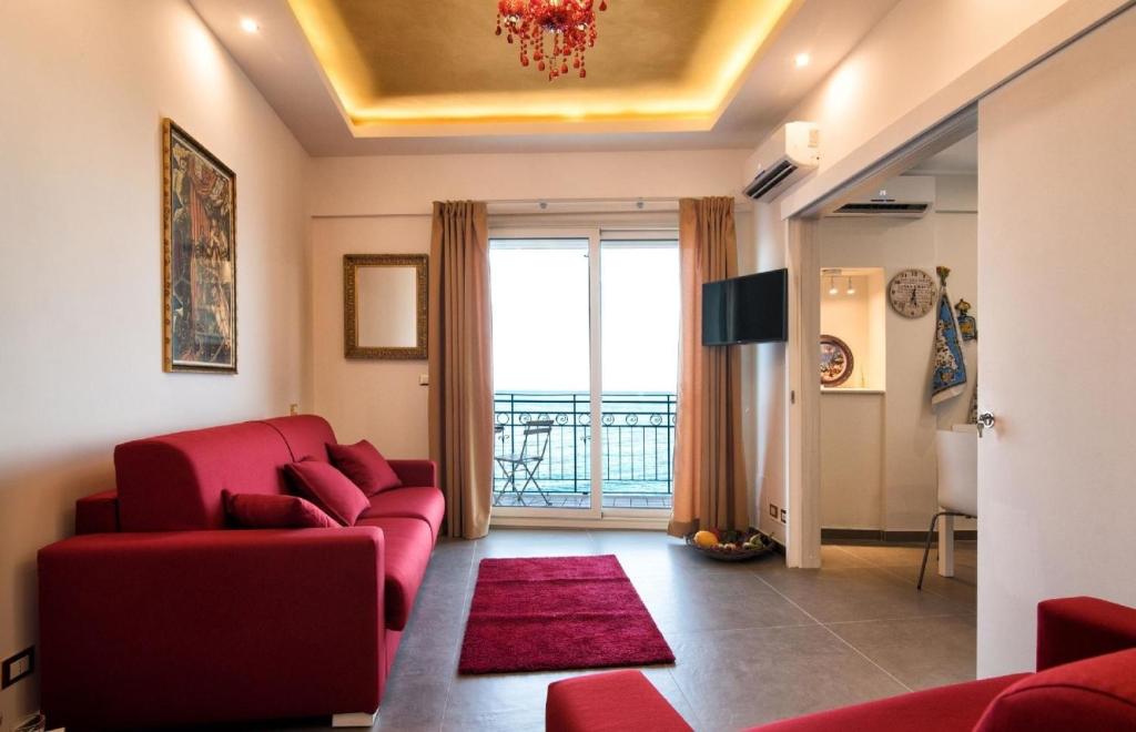 a living room with a red couch and a red rug at Appartement in Naxos - b58780 in Giardini Naxos