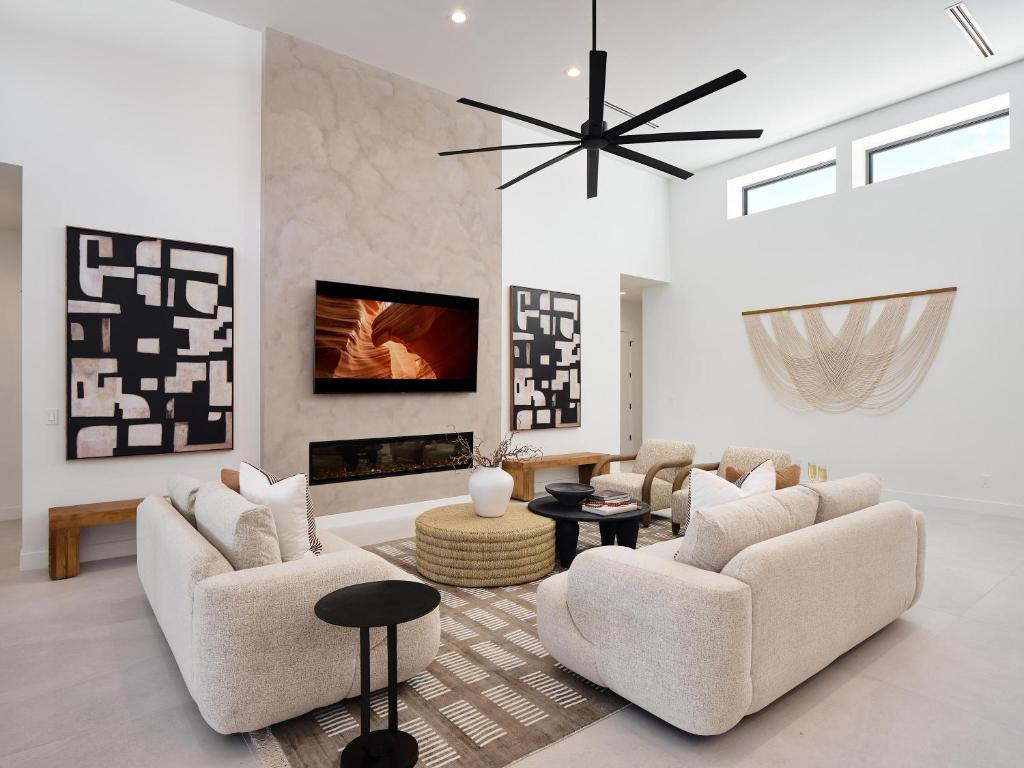 a living room with two chairs and a fireplace at LUXE - Tulum House - New Build - Heated Pool in Scottsdale