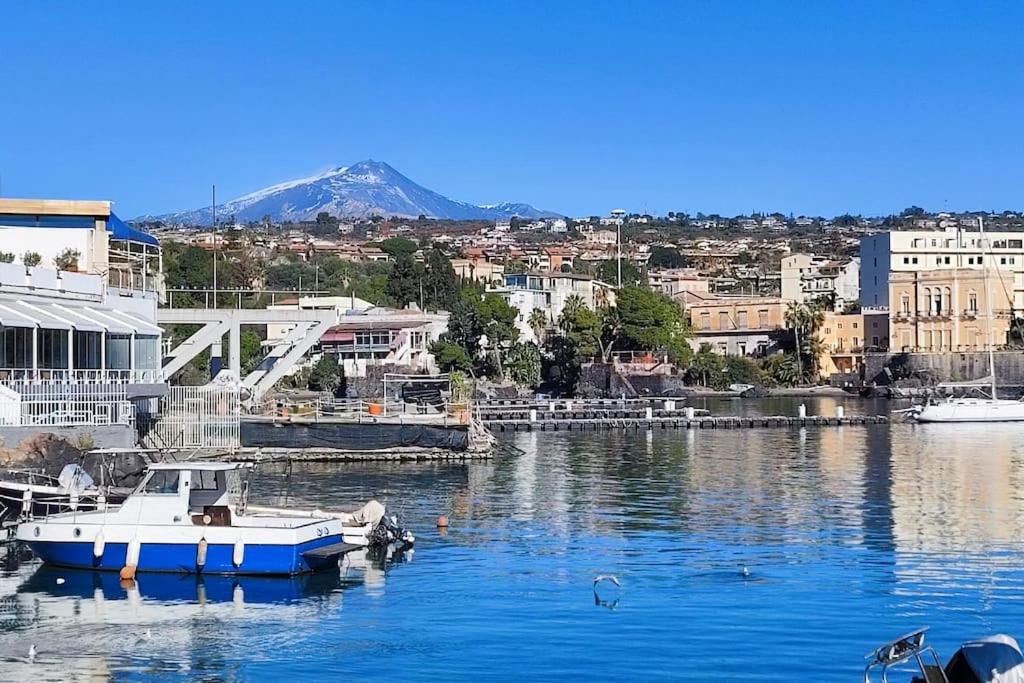 a boat is docked in a body of water at Ognina Marina Gem in Catania