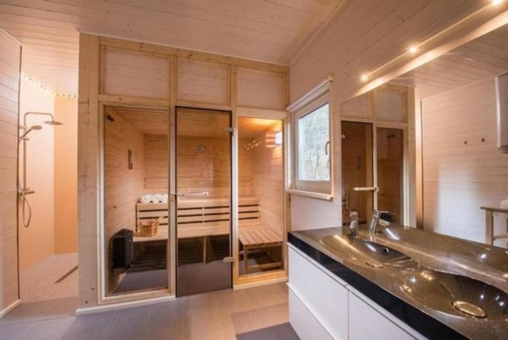 Un baño con dos lavabos y una cama. en Nettes Ferienhaus in Ruhla mit Garten, Grill und Sauna, en Ruhla