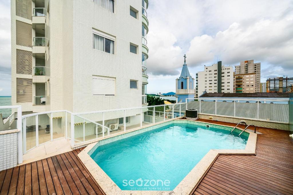a swimming pool on the balcony of a building at Apto Vista Mar cond. c/ piscina e churrasq VCE1102 in Piçarras