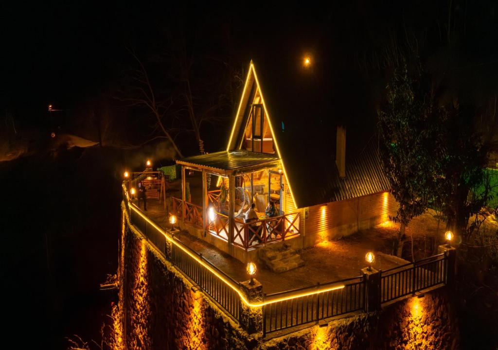 a house lit up at night with lights at Tenta bungalov in Rize