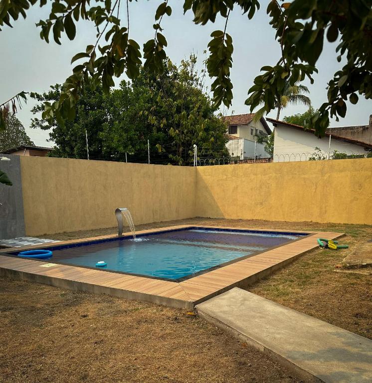 a swimming pool in a backyard with a fence at Residencial Mirandinha. in Boa Vista