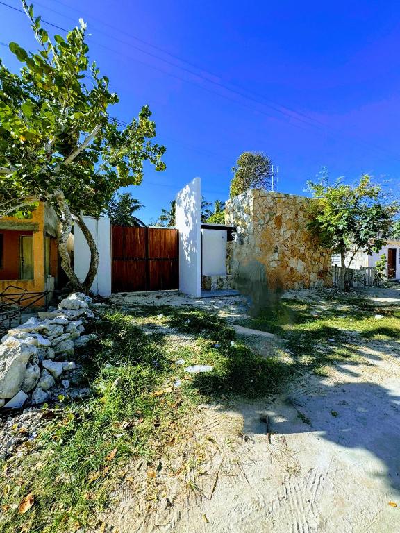 a house with a fence and a yard at Casa Costa Rosa - Habitación Mar in Yuluc