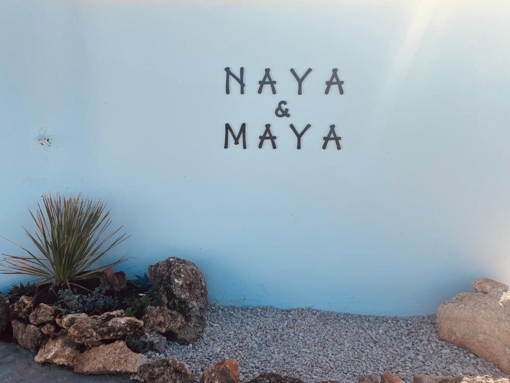 a blue wall with a sign that says maya and mayaaa at Naya pool & garden view bungalow in Koskinou