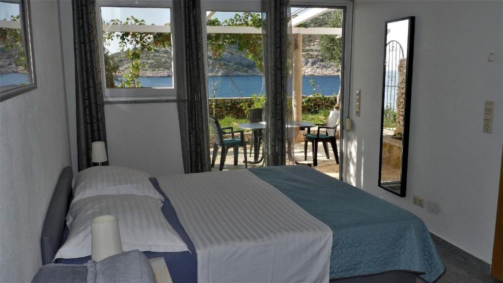 a bedroom with a bed and a view of the ocean at A1-1 Zimmer, 2 Personen in Ražanj