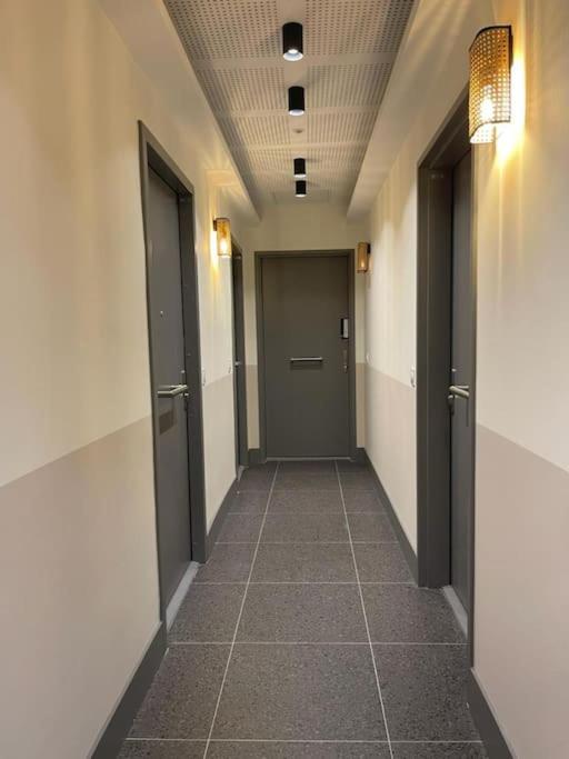 a hallway with two doors and a tile floor at Studio lumineux et climatisé in Nice