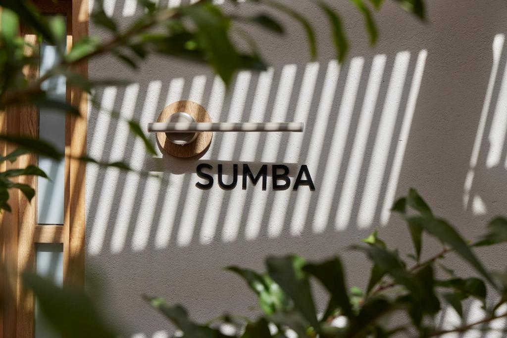 a sign on a door with the word sunba on it at ANTIPODA HOTEL Boutique in Medellín