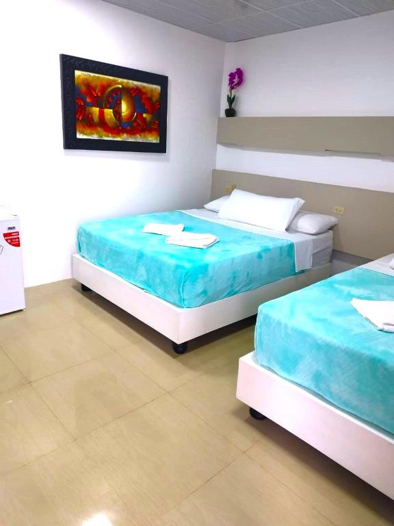 Postel nebo postele na pokoji v ubytování Hotel Los Algarrobos