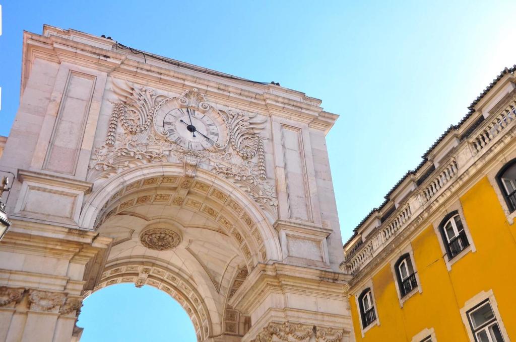 a building with a clock on top of it at Charming apartment on Rua Augusta in Lisbon