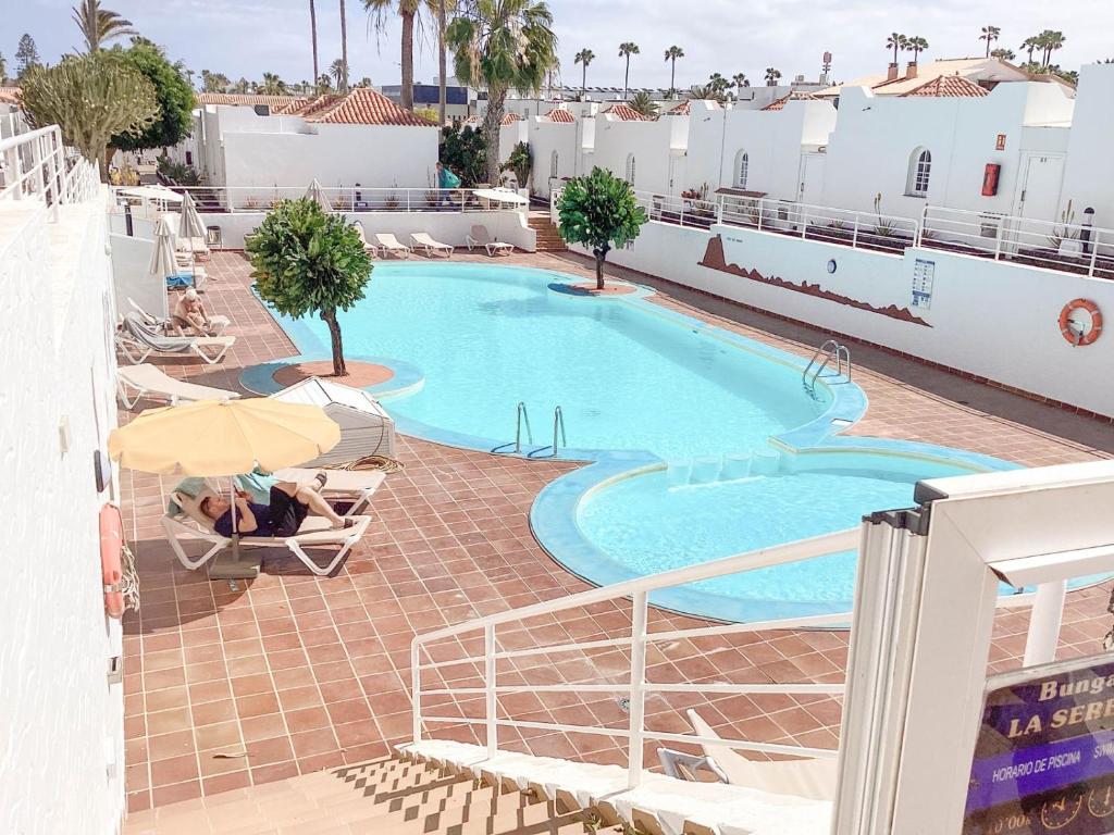 a swimming pool on the roof of a hotel at CASA MIRAMAR in Corralejo
