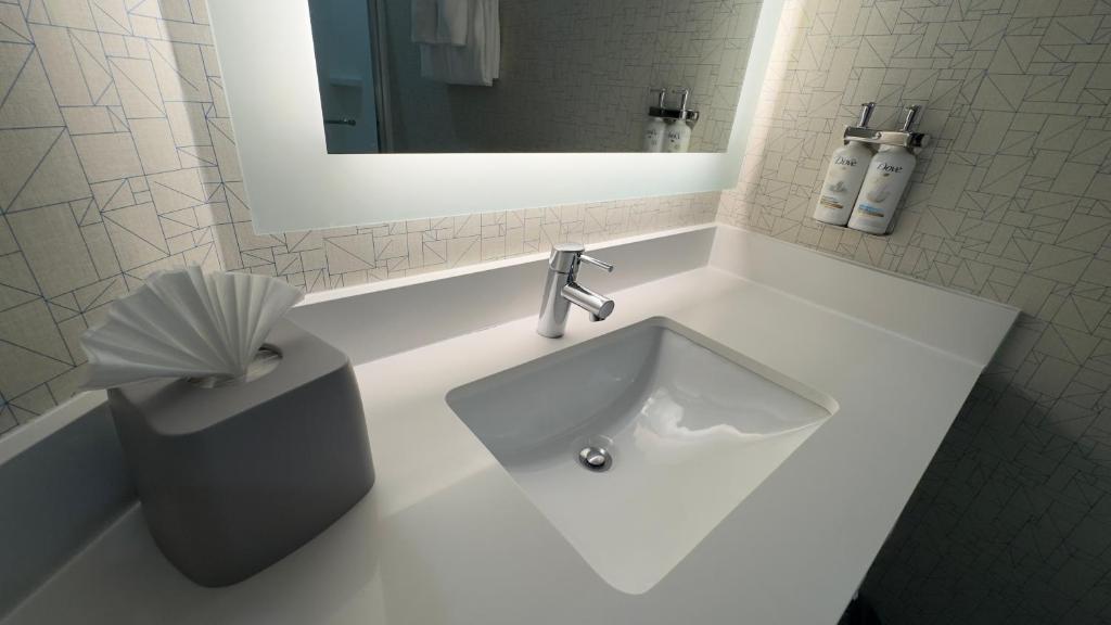 a white sink in a bathroom with a mirror at Holiday Inn Express Hotel & Suites Marina, an IHG Hotel in Marina