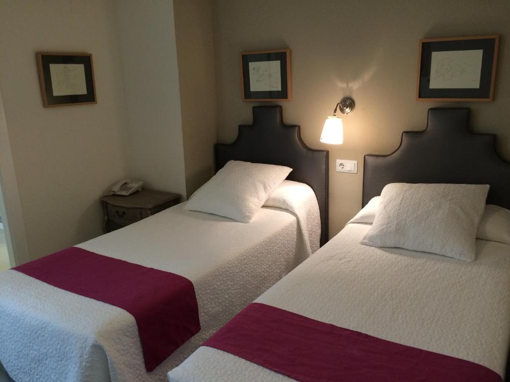 Postel nebo postele na pokoji v ubytování Hotel Jávea