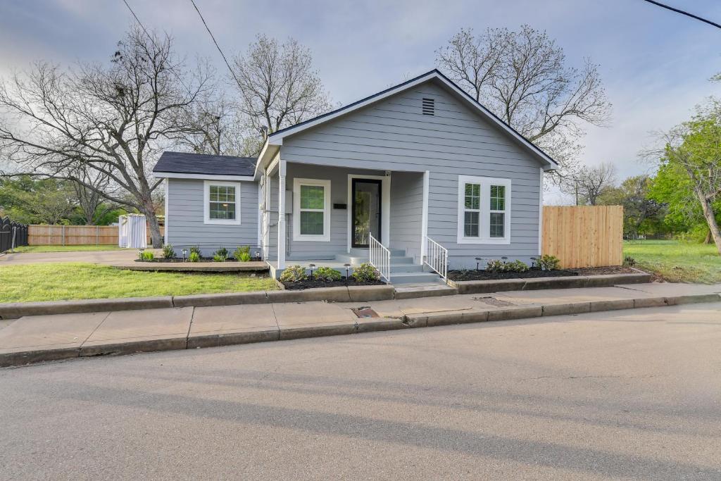a small house on the side of a street at Lovely Waco Retreat with Yard and Patio 2 Mi to Dtwn! in Waco
