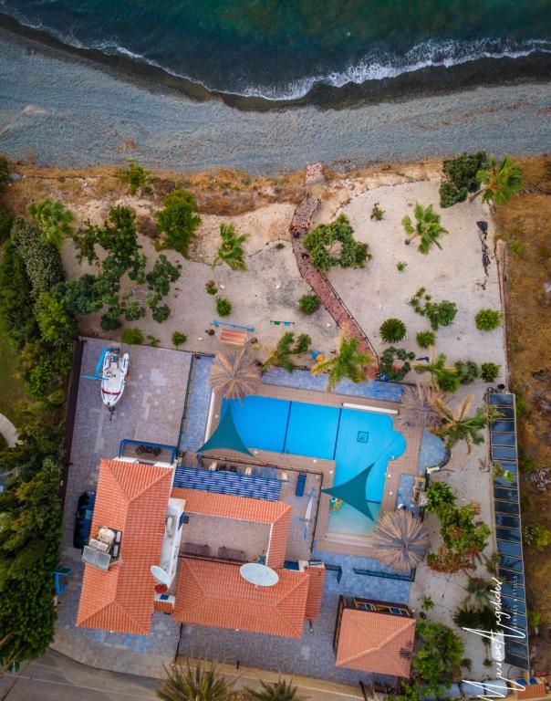 an aerial view of a resort with a beach at Astrofegia Beachfront Villa in Pomos