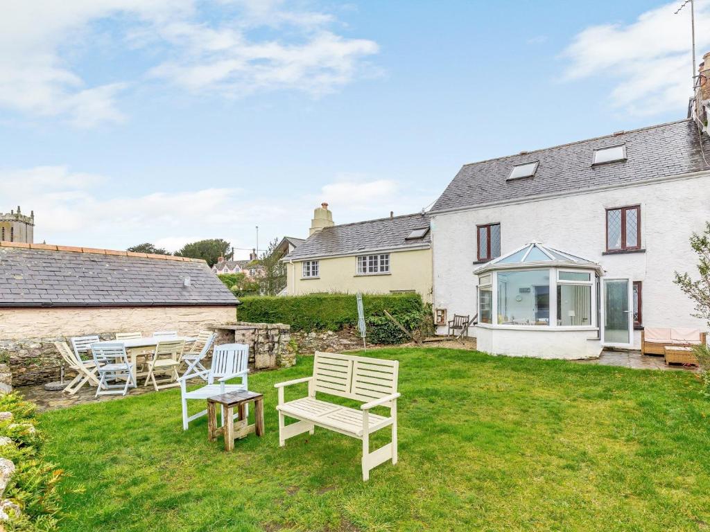 a yard with chairs and tables and a house at 4 Bed in Bere Alston RTIDE in Tamerton Foliot