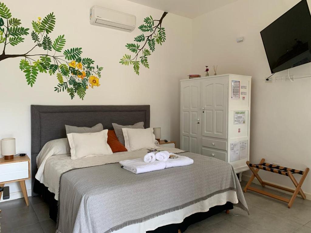 a bedroom with a bed with two towels on it at Las Tipas mini loft Cafayate in Cafayate