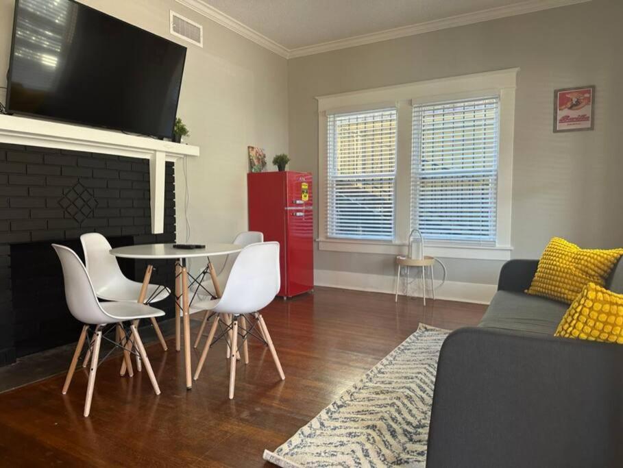 a living room with a table and white chairs at Luxury Stay in Montrose- Parma _ the Italian Plaza in Houston