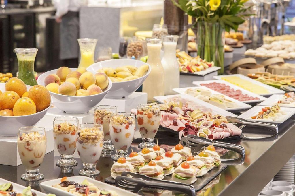 a buffet with plates of food on a table at Radisson Bogota Metrotel in Bogotá