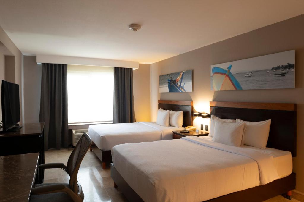 Postel nebo postele na pokoji v ubytování Hilton Garden Inn Veracruz Boca del Rio
